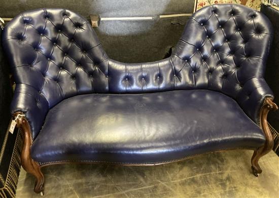 A Victorian mahogany double spoon back settee upholstered in dark blue button leather, width 180cm, depth 180cm, height 95cm